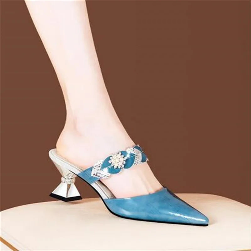 Elegant pointed toe designer slides adorned with rhinestones, showcasing luxury and style for women.