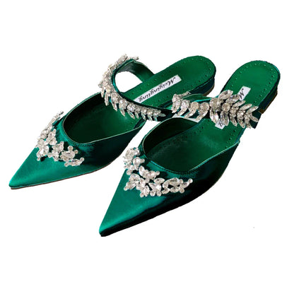 Fashion-forward pointed stiletto mules sandals, designed for upscale summer events, showcasing a luxurious silk finish and radiant rhinestone accents.