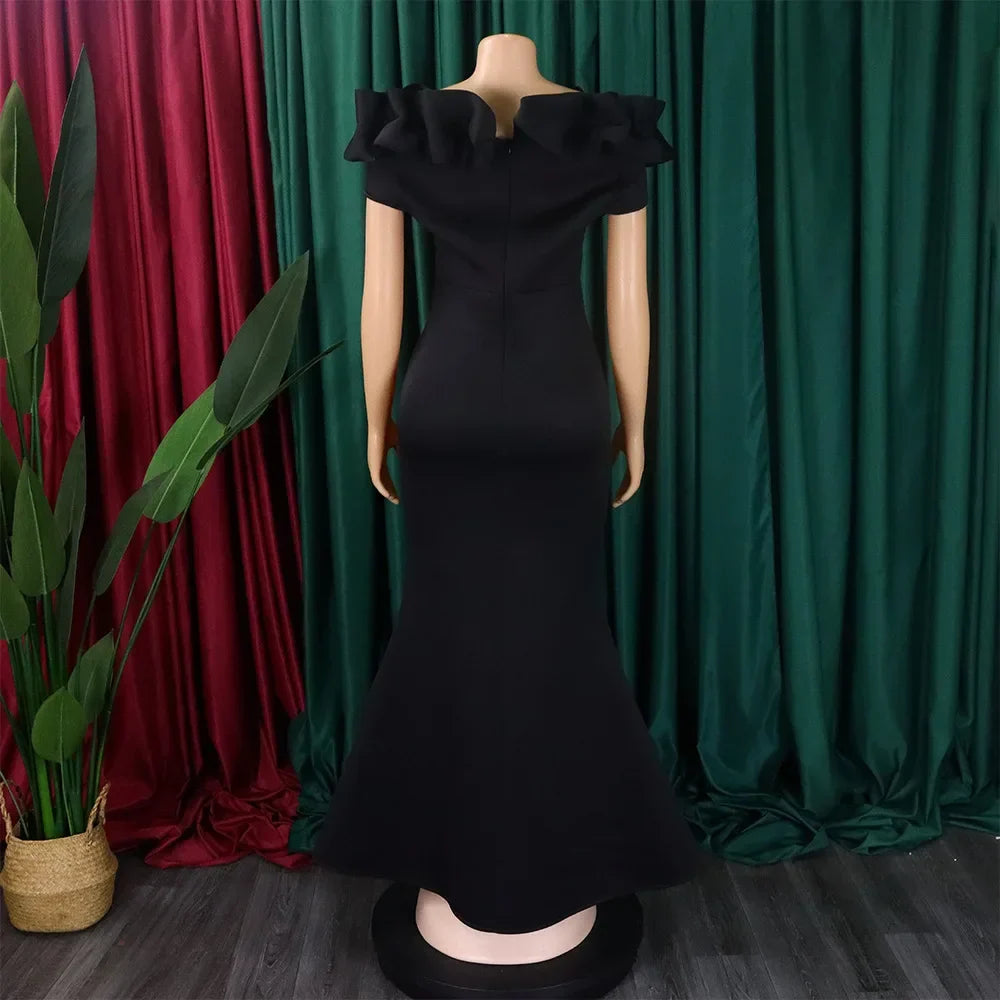 Dazzling floor-length mermaid dress in a solid hue, designed with a plunging neckline and off-the-shoulder sleeves, exuding effortless glamour.