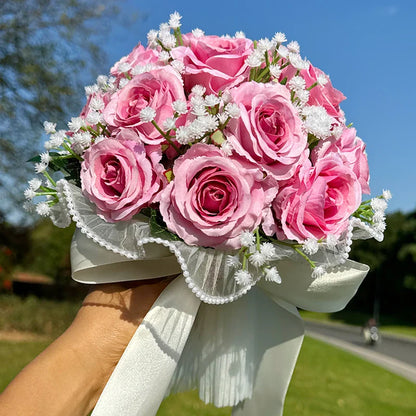 Charming silk wedding bouquet perfectly crafted with babysbreath roses, accented with luxurious pearl lace for a bride's special day.