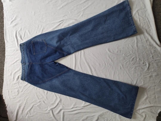 Close-up of CM.YAYA Women's Flare Jeans detailing the mid-waist and stylish hollow cutouts for a trendy and luxurious look.