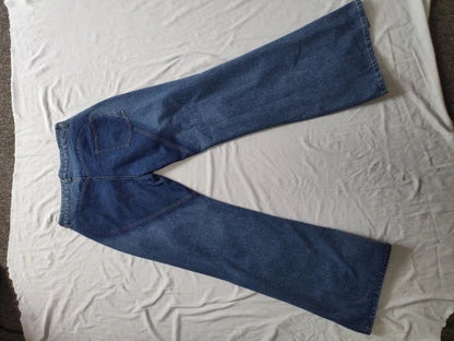 Close-up of CM.YAYA Women's Flare Jeans detailing the mid-waist and stylish hollow cutouts for a trendy and luxurious look.