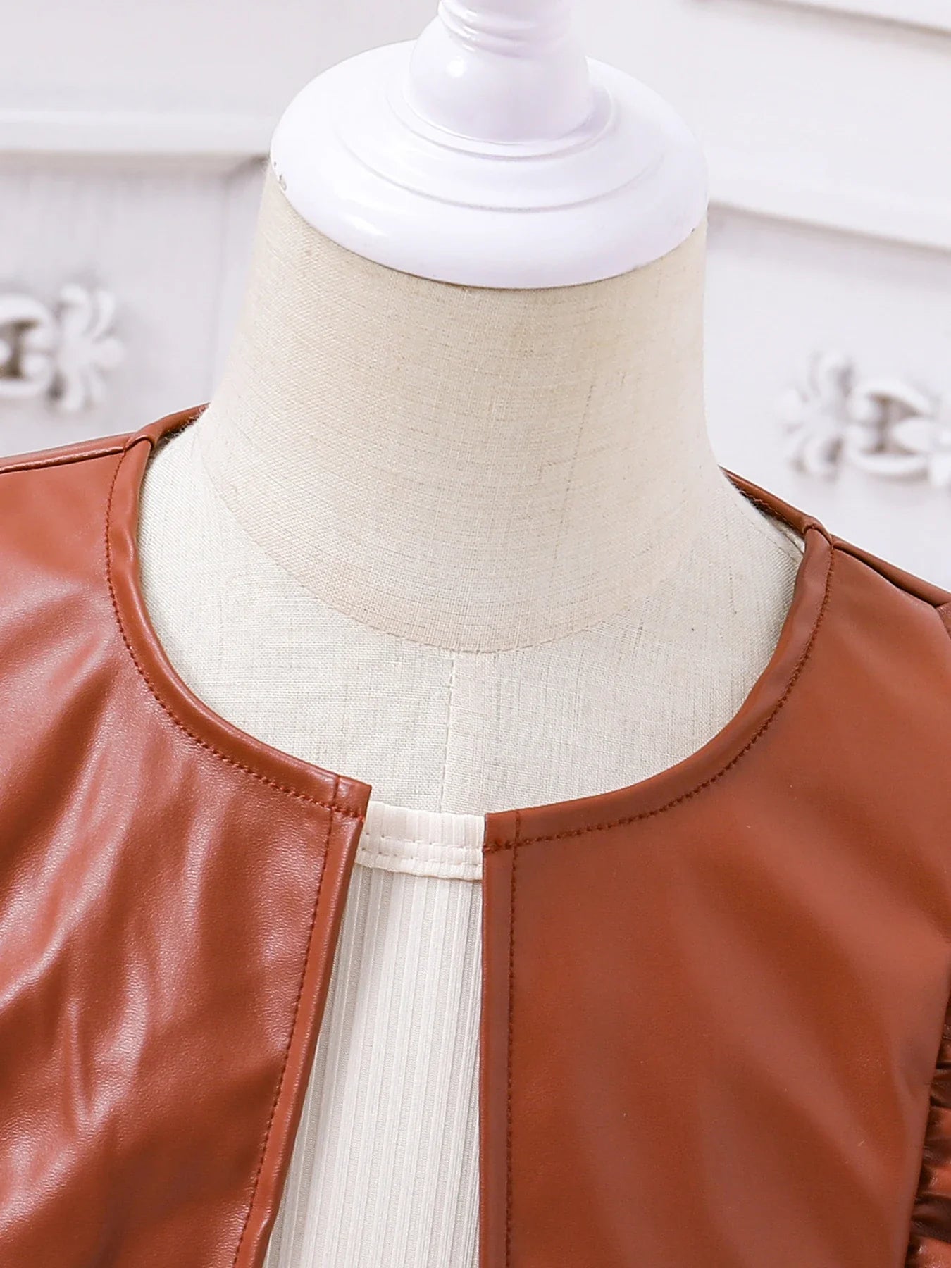 Chic PU leather vest paired with an elegant skirt in a luxurious two-piece outfit for girls aged 4-6.