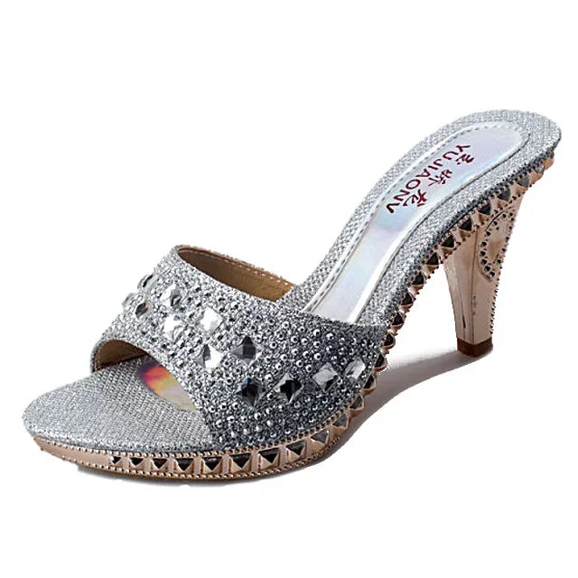 Chic Women's Slip-On Sandals adorned with rhinestones, showcasing their stunning silver hue, perfect for glamorous parties.