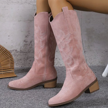 Elegant knee-high Chelsea cowboy boots for women, featuring modern mid heels and a refined zipper closure, perfect for adding a punk chic element to any outfit.