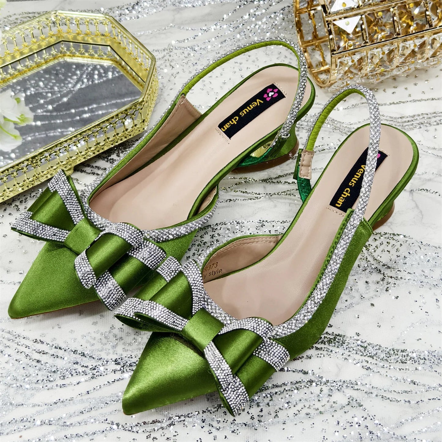 Chic matching bag set for women, adorned with a metallic handle, perfectly complementing stylish low heel pumps.