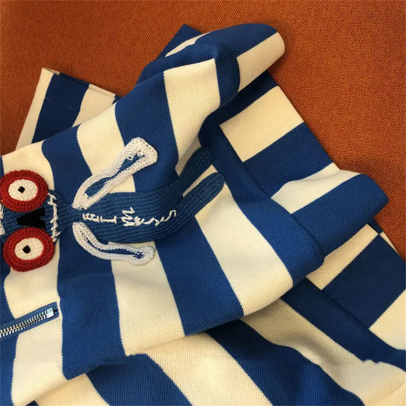 Sophisticated women's striped sportswear ensemble, combining comfort and luxury in a modern pullover style with a loose fit.