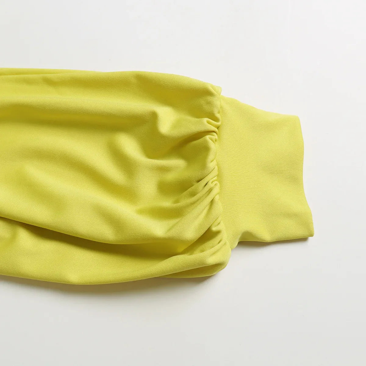 Side view of a stylish jumpsuit for women, capturing the fluid silhouette of wide leg trousers and a modern stand neck.