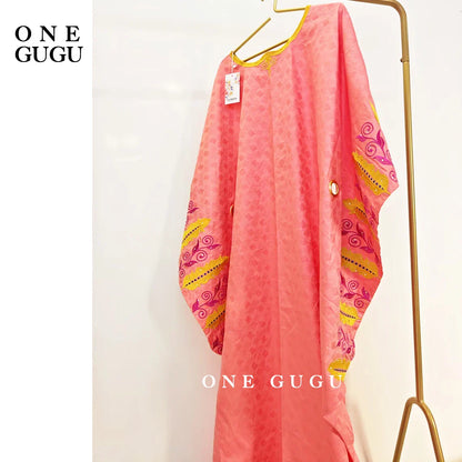 Women modelling the Luxury Royal Blue Bazin Riche Boubou Dress at a wedding, demonstrating its versatility for special occasions and daily wear.