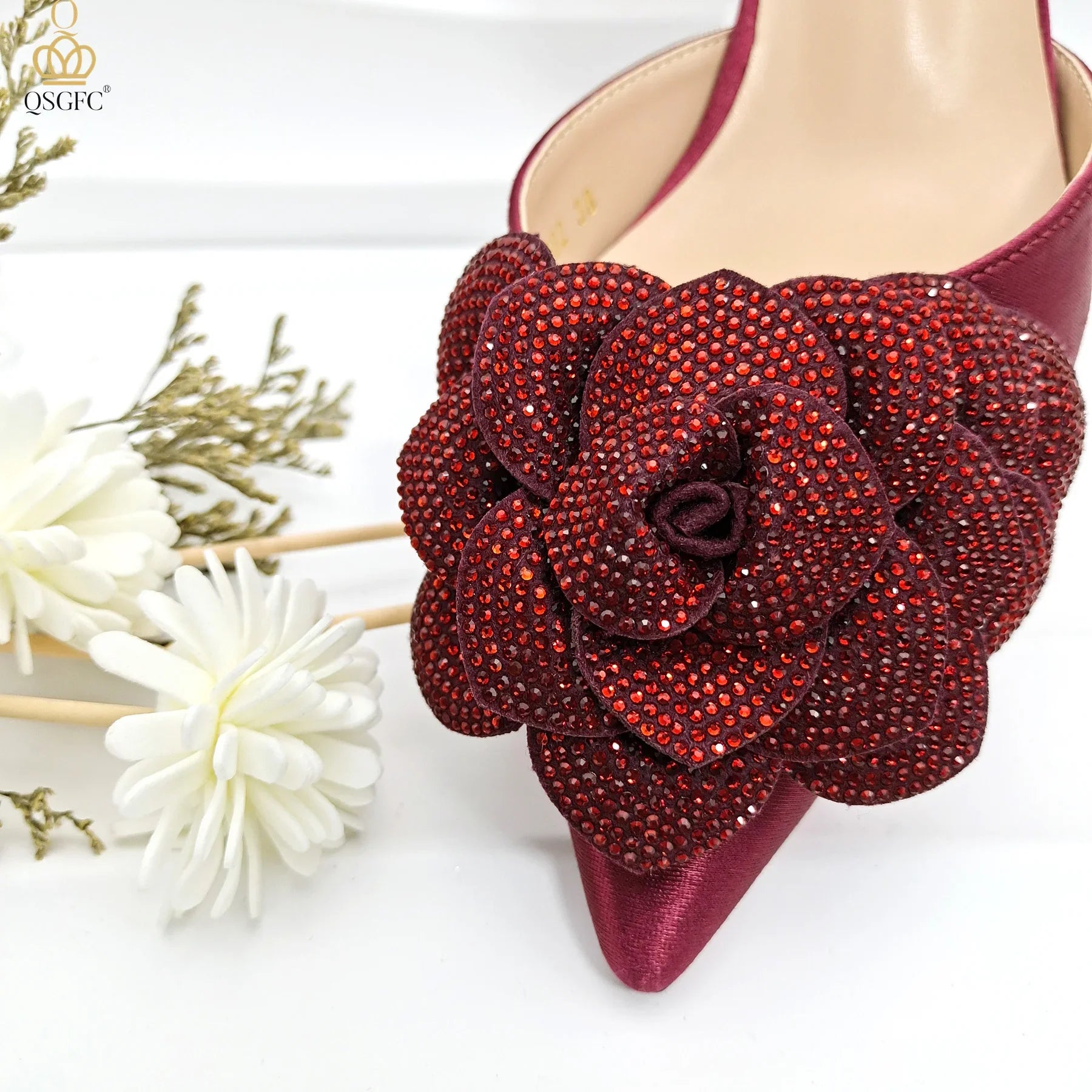 Elegant QSGFC Women's Pump shoes with a unique ankle strap and floral details, perfect for elevating evening attire.