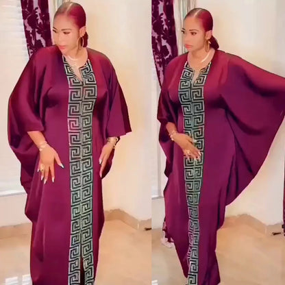 Stylish plus size African woman wearing a bat sleeve V-neck maxi dress, perfect for spring and summer occasions, exuding elegance and confidence.