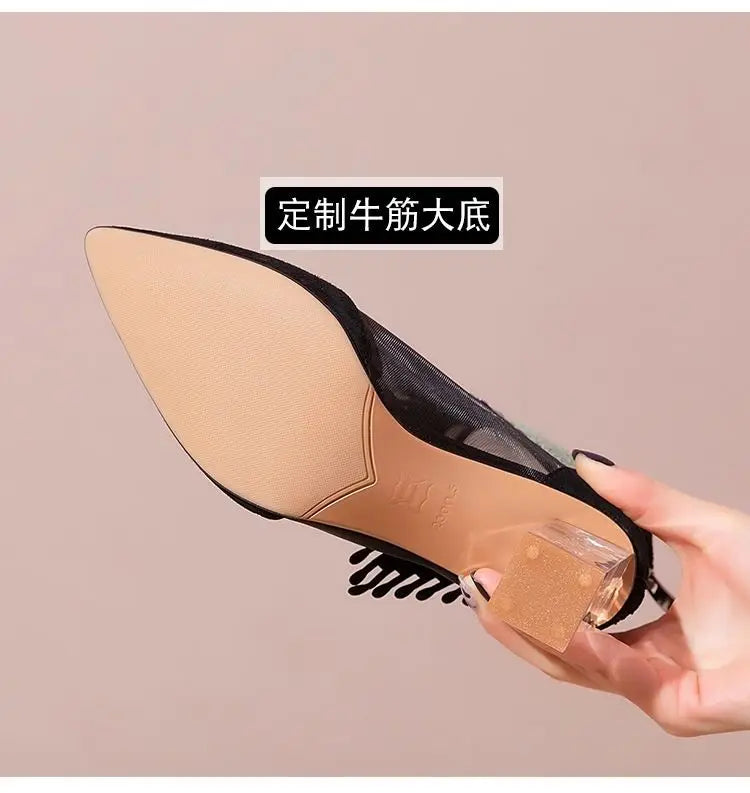 Luxurious women’s pointed toe high heel dance boots with intricate rhinestone detailing and playful tassels, designed for elegance and style.