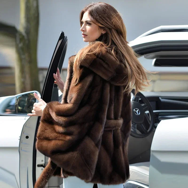 Chic women's faux fur coat draped elegantly, highlighting its high-street fashion appeal and comfortable fit.
