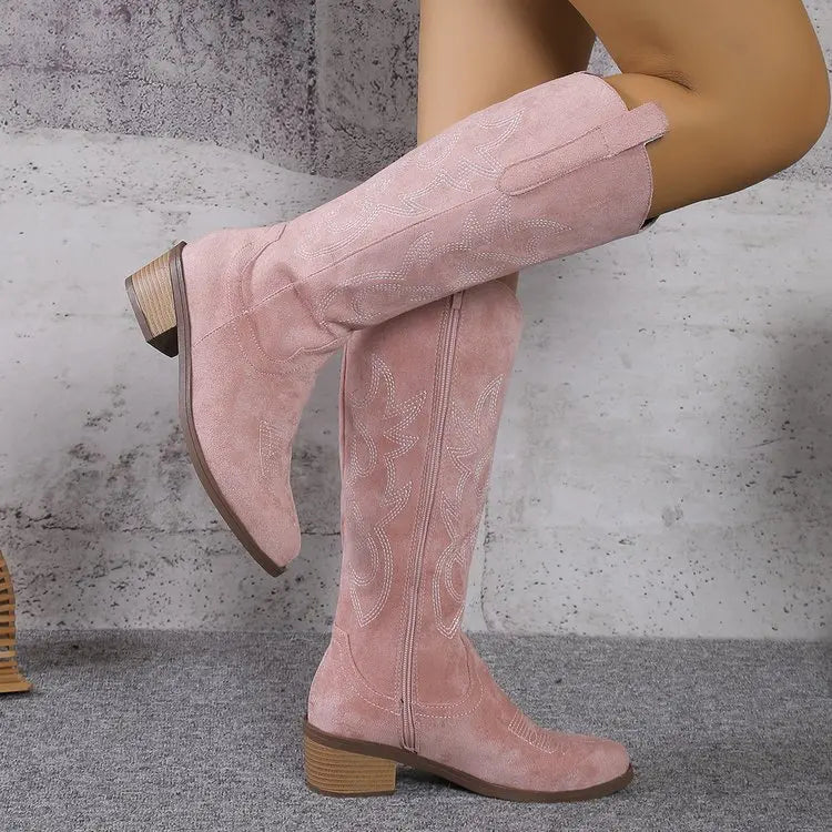 Luxury women's Chelsea cowboy boots in knee-high style, offering a sleek design and mid-height heels for sophisticated styling.