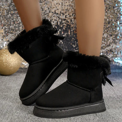 Luxury flat-heeled winter boots for women with a minimalist design, featuring a bow detail, made from high-quality microfiber for ultimate comfort.