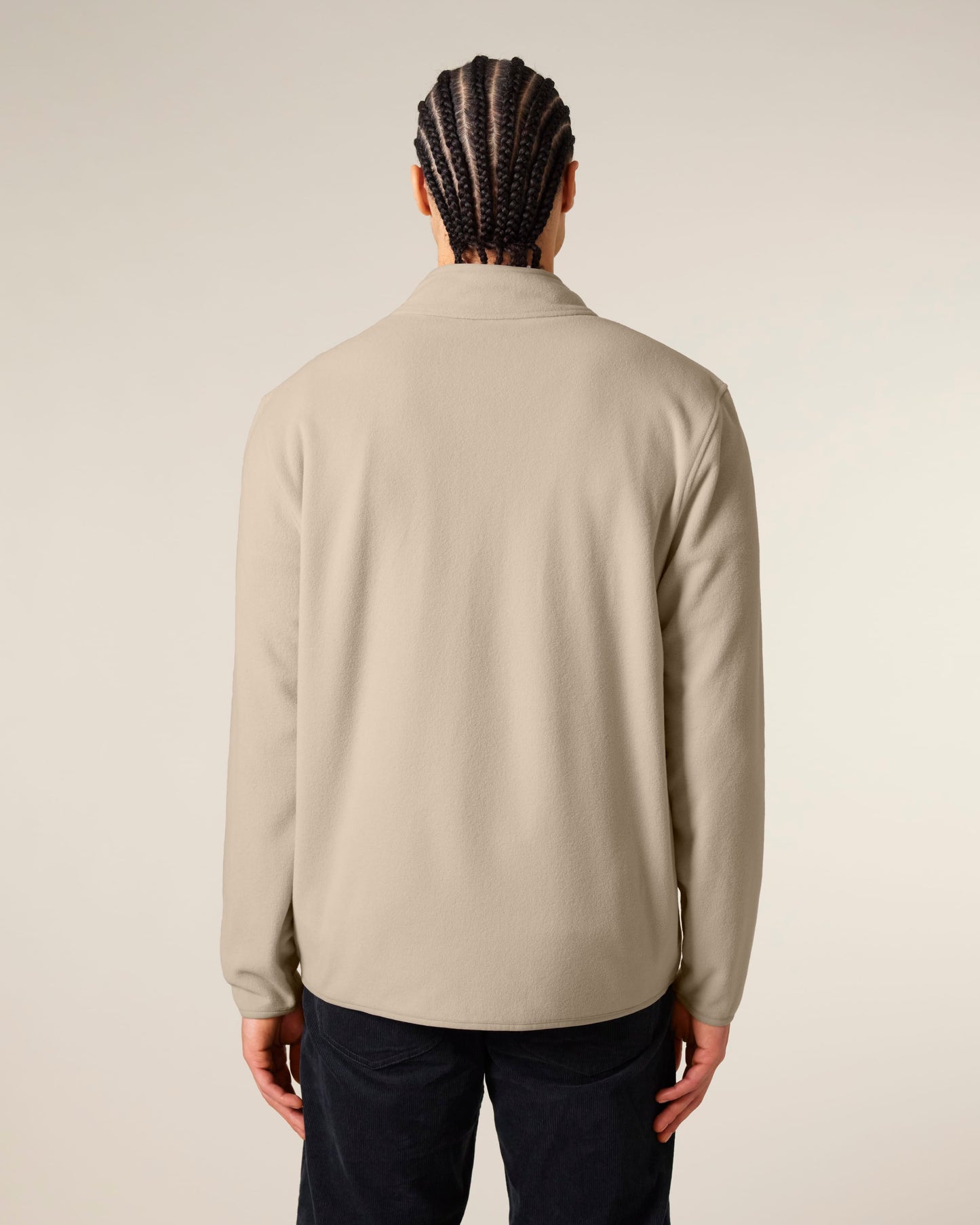 Close-up detail of men's luxurious fleece jacket showcasing anti-pill finish and plush texture, made from 100% recycled materials.