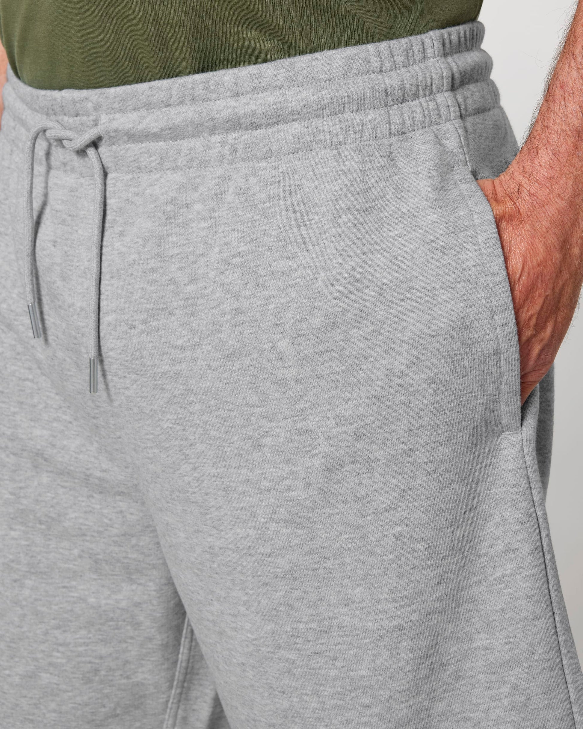 Stylish unisex jogger shorts showcasing the self-fabric elastic waistband and matching round drawcords, emphasising modern design and comfort in an eco-friendly fashion.