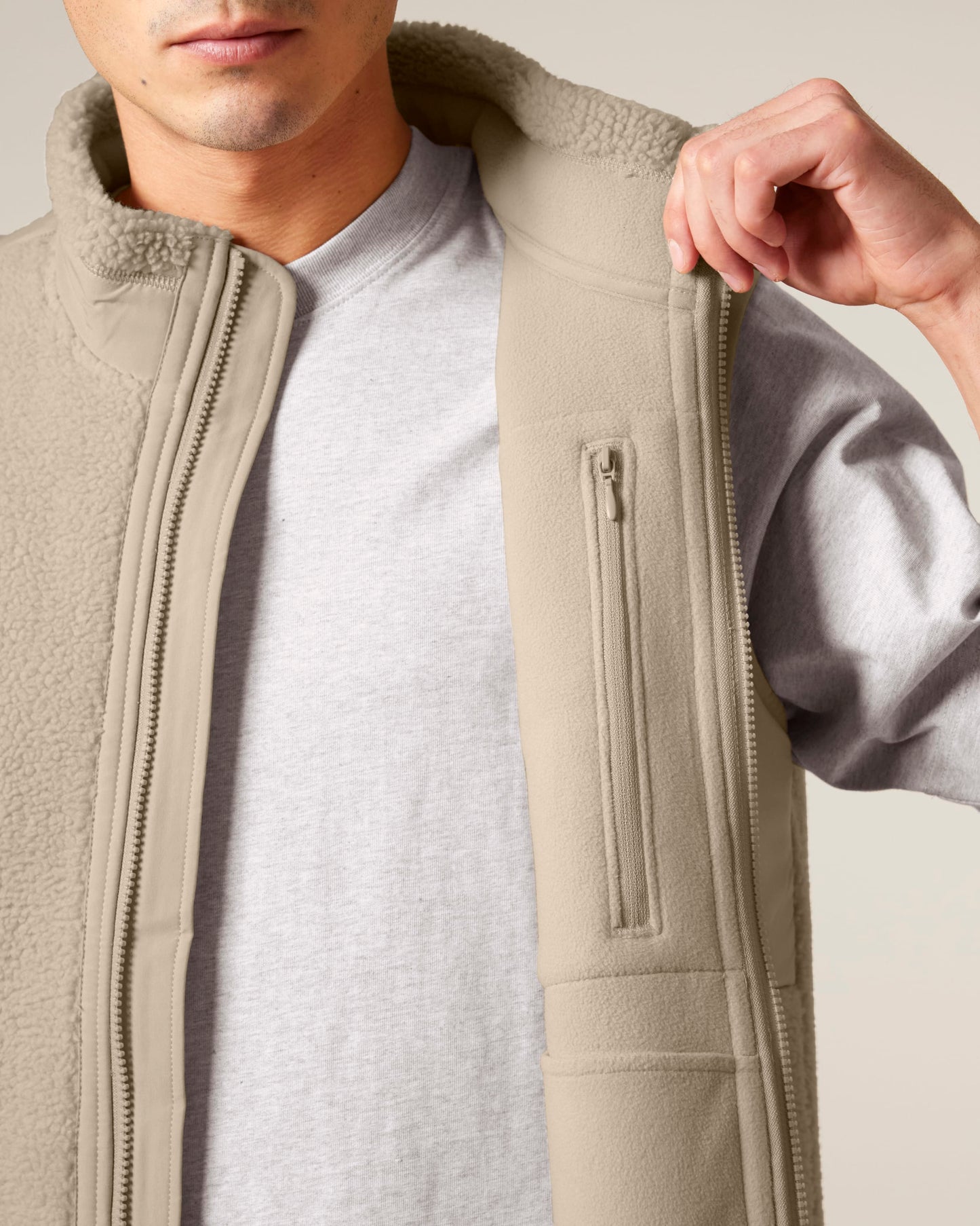 Unisex recycled bodywarmer styled elegantly against a backdrop of nature, perfect for eco-conscious explorers.