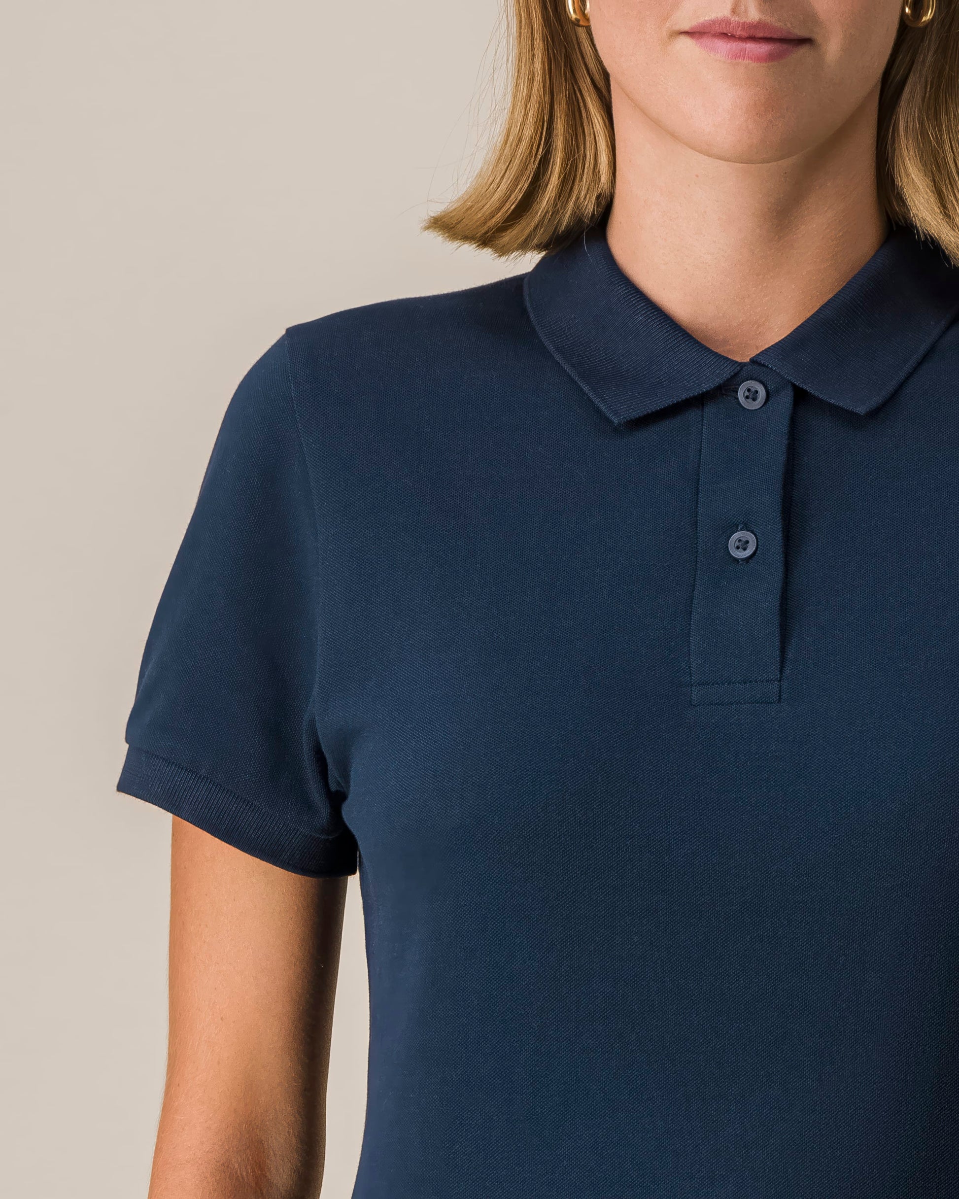 Stylish women's organic cotton polo shirt in a vibrant royal blue, offering a perfect blend of comfort and elegance.