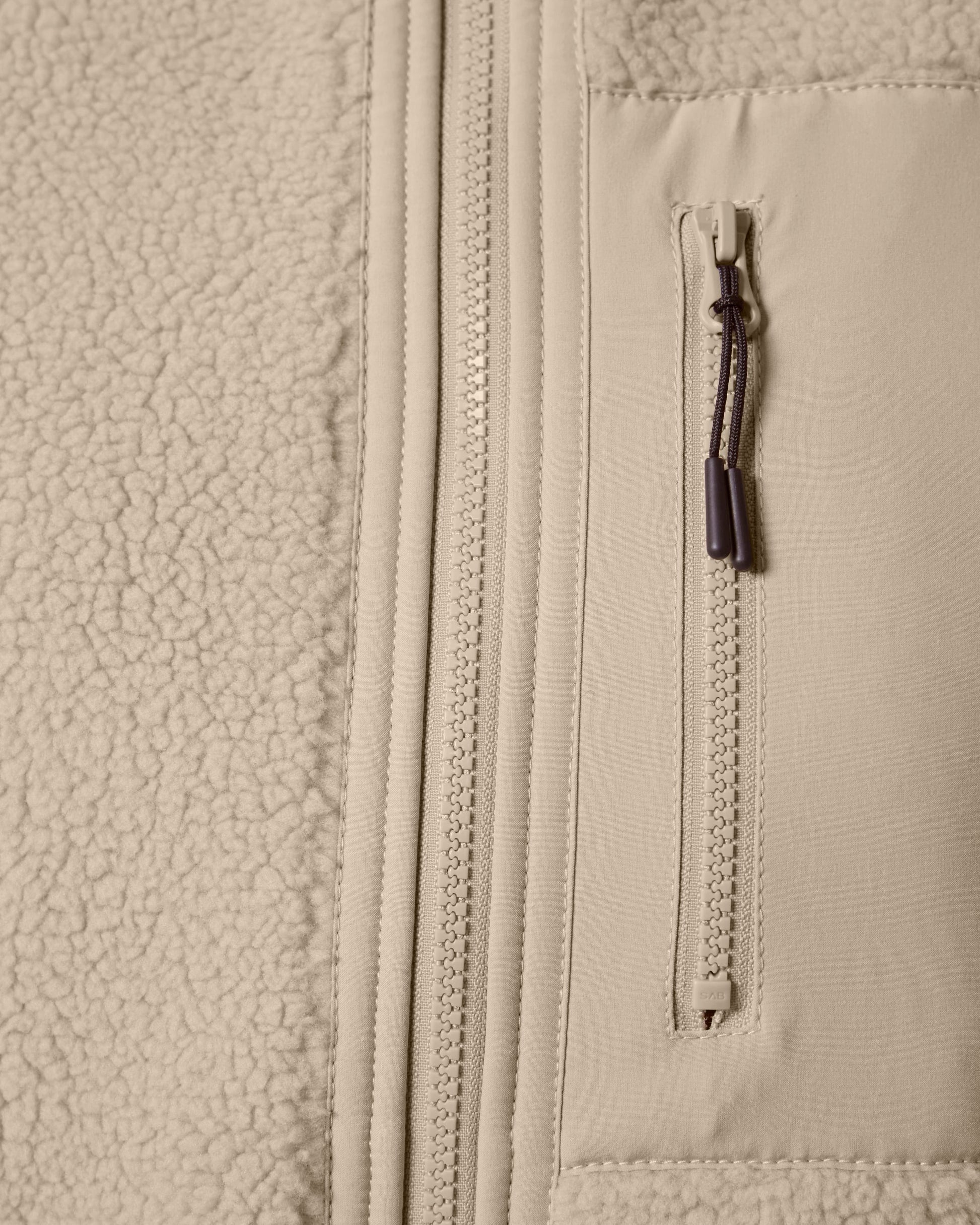 Unisex sherpa fleece bodywarmer draped stylishly on a mannequin, illustrating its versatility and eco-friendly design.