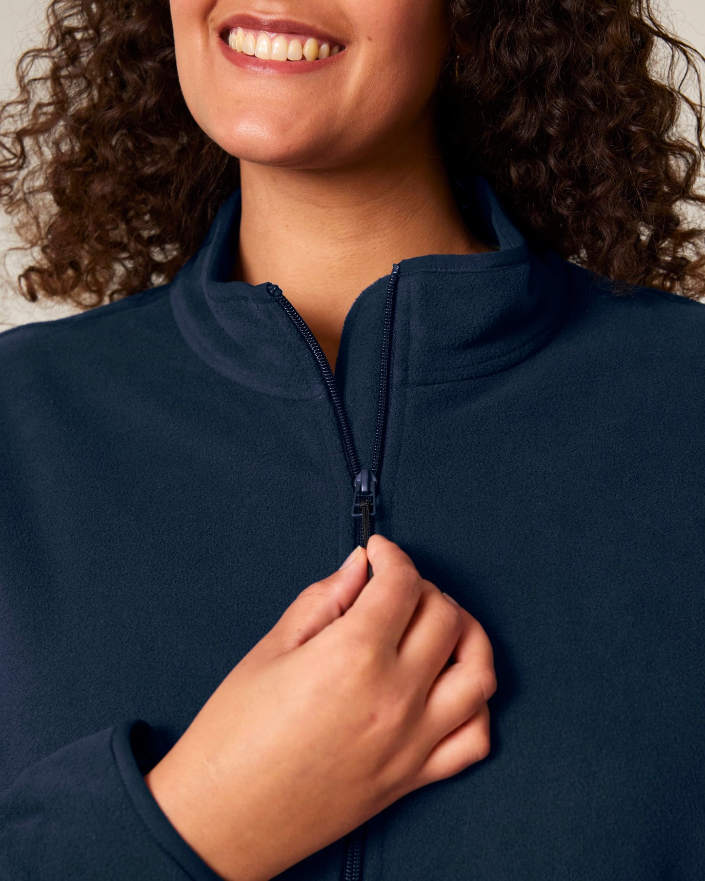 Sustainable women's fleece jacket displayed in a serene outdoor setting, emphasising its eco-friendly materials and luxurious appeal.