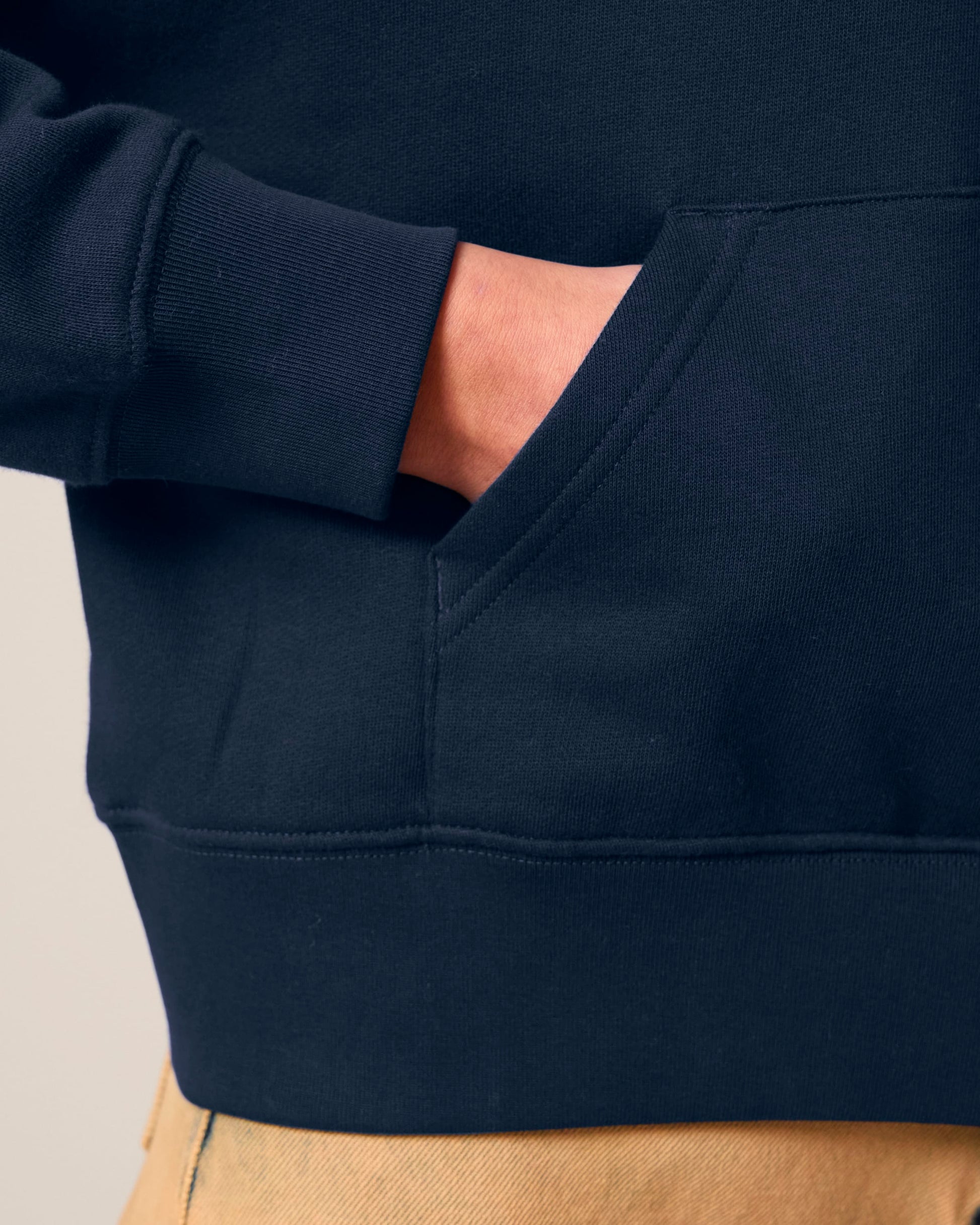 Close-up of soft 300 GSM fleece fabric on a women's hoodie, showcasing its premium organic cotton quality and brushed texture.