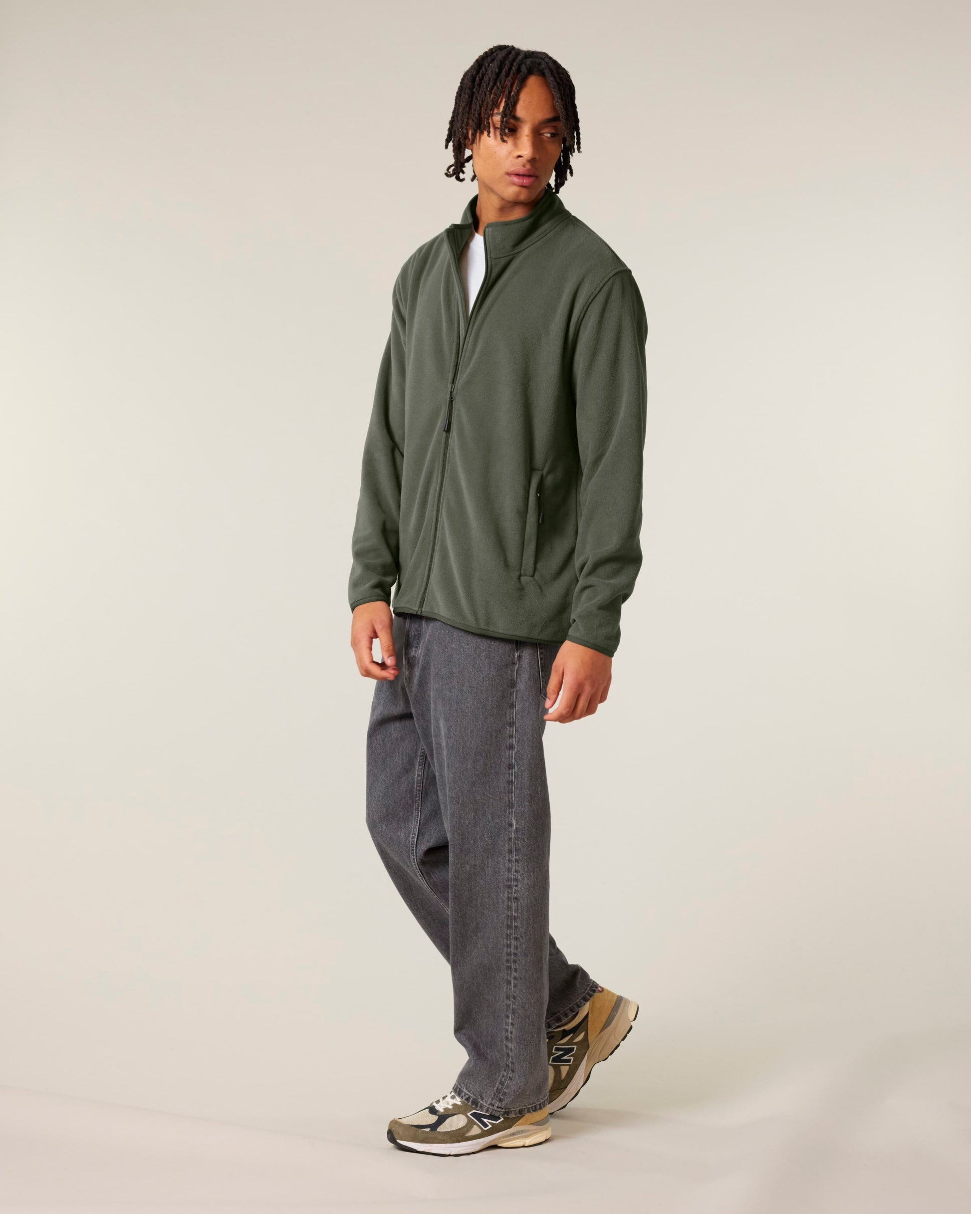 A lifestyle image of a man in a luxurious recycled fleece jacket, illustrating the stylish design and versatility of eco-friendly apparel.