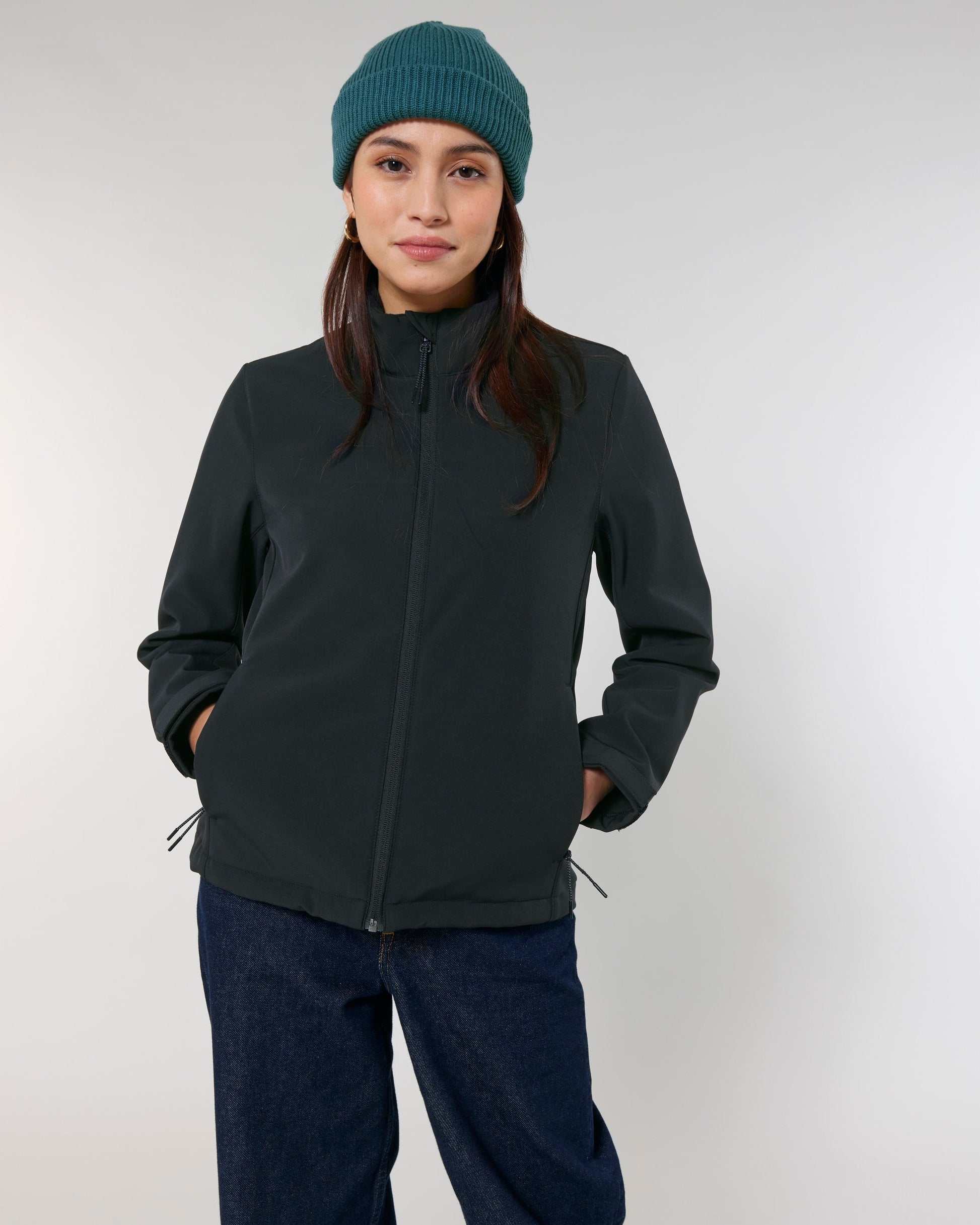 Chic women's softshell jacket against a scenic backdrop, ideal for those seeking a fusion of style and eco-friendly functionality.