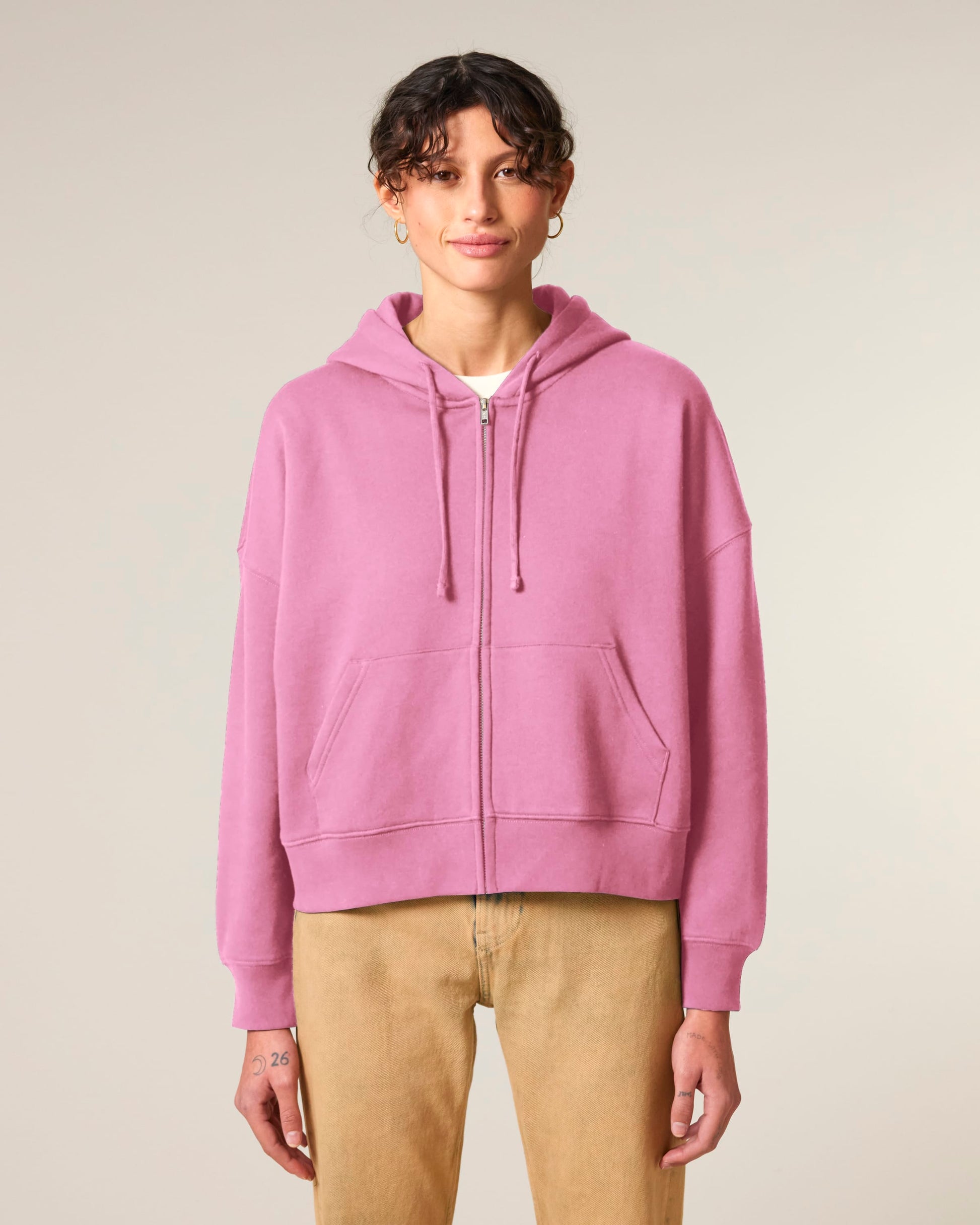 Stylish women's hoodie worn open over a tee, highlighting its versatile layering options and elegant silhouette for casual and elevated looks.