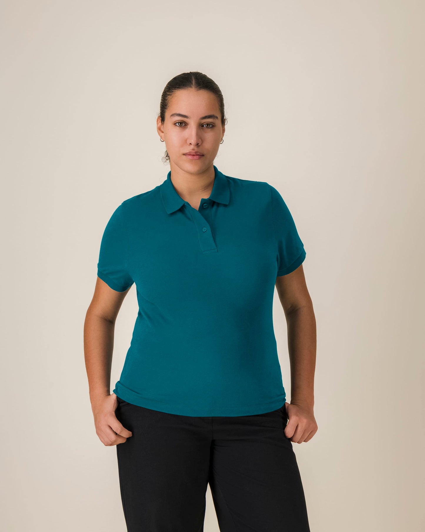 Trendy women's polo shirt in a flattering fit, crafted from breathable organic cotton in a stunning pastel pink.