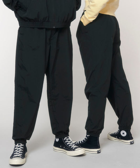 Luxurious eco-friendly recycled nylon tracksuit bottoms for men and women, showcasing a sophisticated design for ultimate comfort.