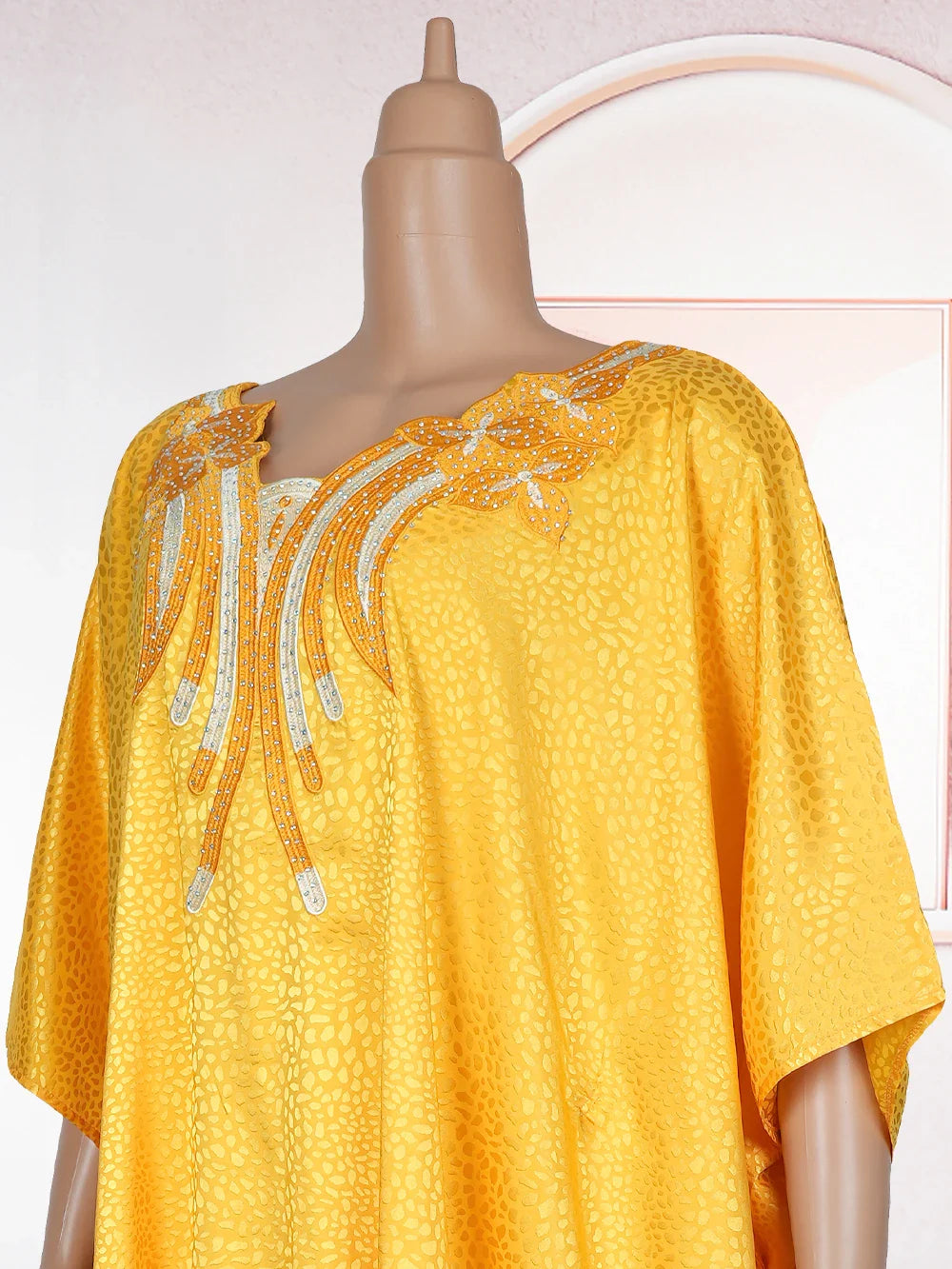 Gorgeous loose-fitting kaftan dress in premium satin fabric, adorned with intricate embroidery, perfect for stylish Muslim women seeking elegance.