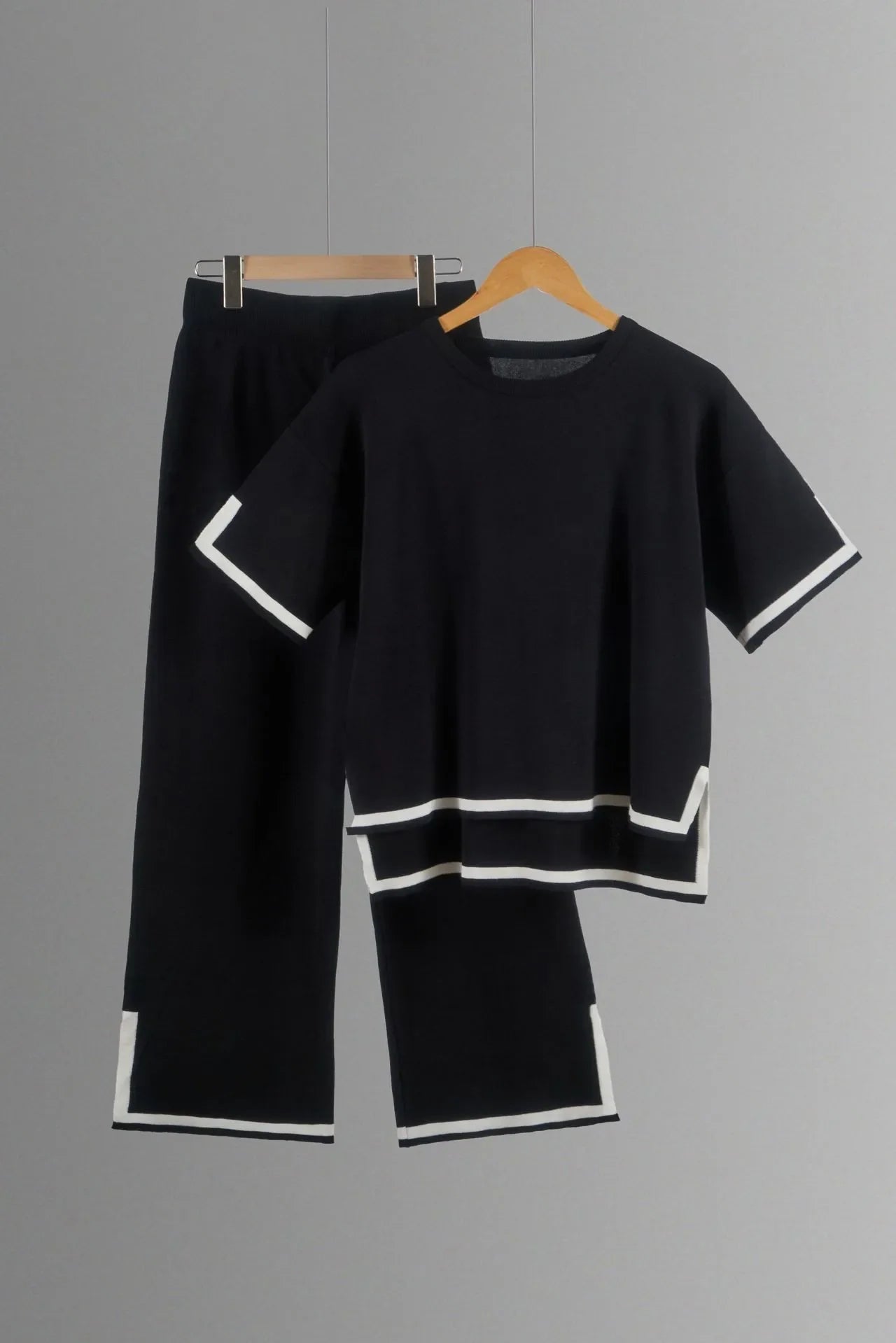 Close-up view of luxurious polyester and cotton fabric of an elegant women's knitted trousers suit, showcasing the rich texture and quality craftsmanship.