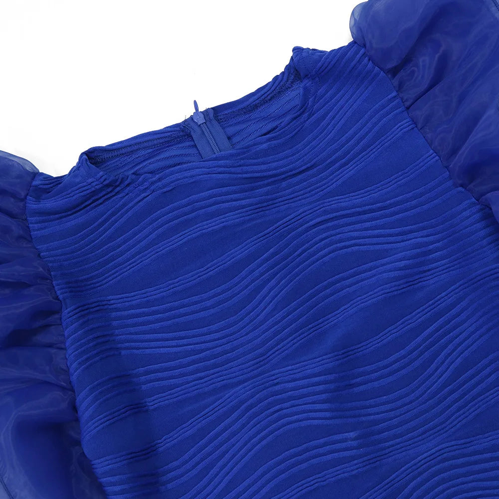 Close-up of CM.YAYA women's striped knee-length dress showcasing premium polyester fabric and captivating ruffles, designed for a stylish evening look.