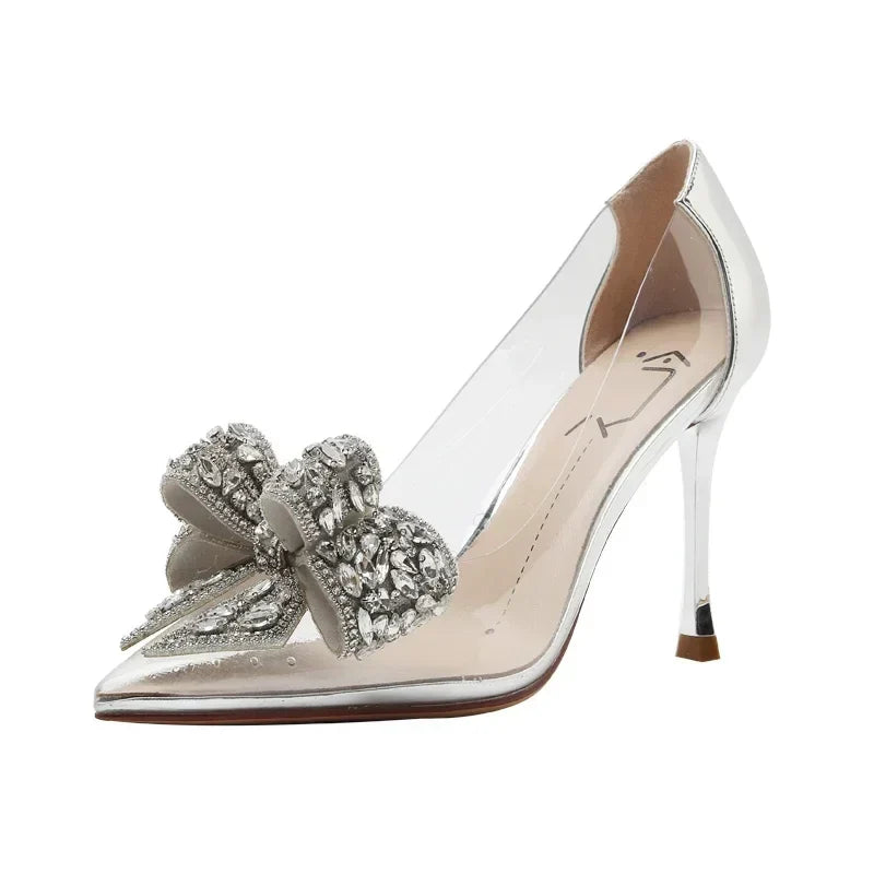 Exquisite transparent high heels with a thin heel and diamond accessories, embodying elegance and style for the modern woman.