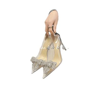 Side profile of elegant transparent heeled sandals for women, showcasing a thin heel and luxurious rhinestone details for a chic look.