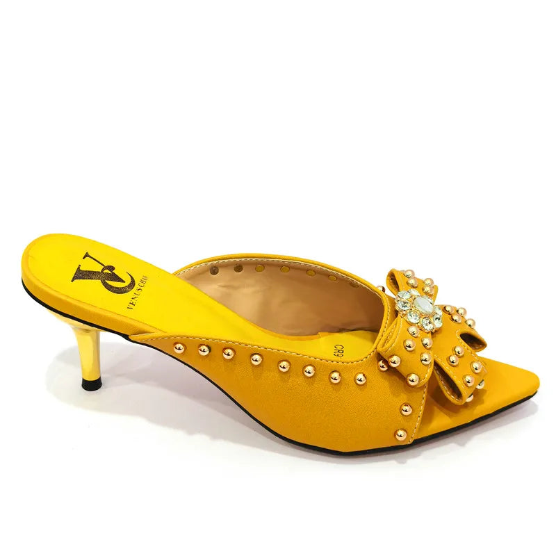 Refined women's high heeled pumps featuring a stylish rivet design, showcased in a vibrant hue to complement any summer outfit.