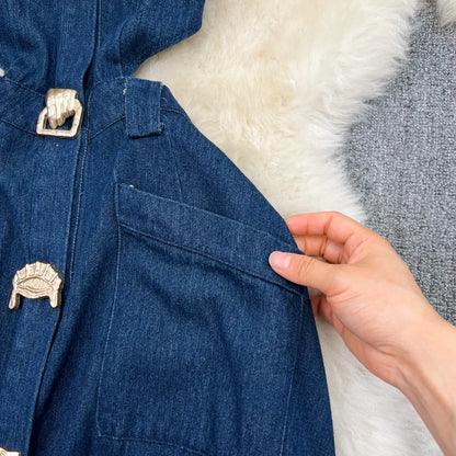 Close-up of luxurious polyester fabric of the sleeveless denim dress, showcasing its refined texture and elegant silhouette.