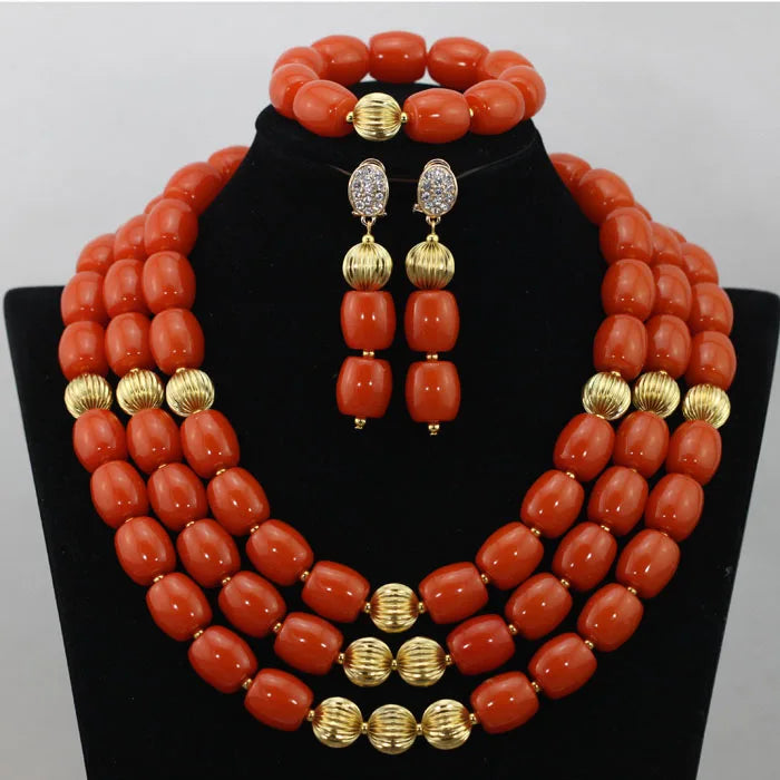 Complete luxury jewelry set comprising a necklace, earrings, and bracelet, adorned with African beads and artificial coral, perfect for special occasions.