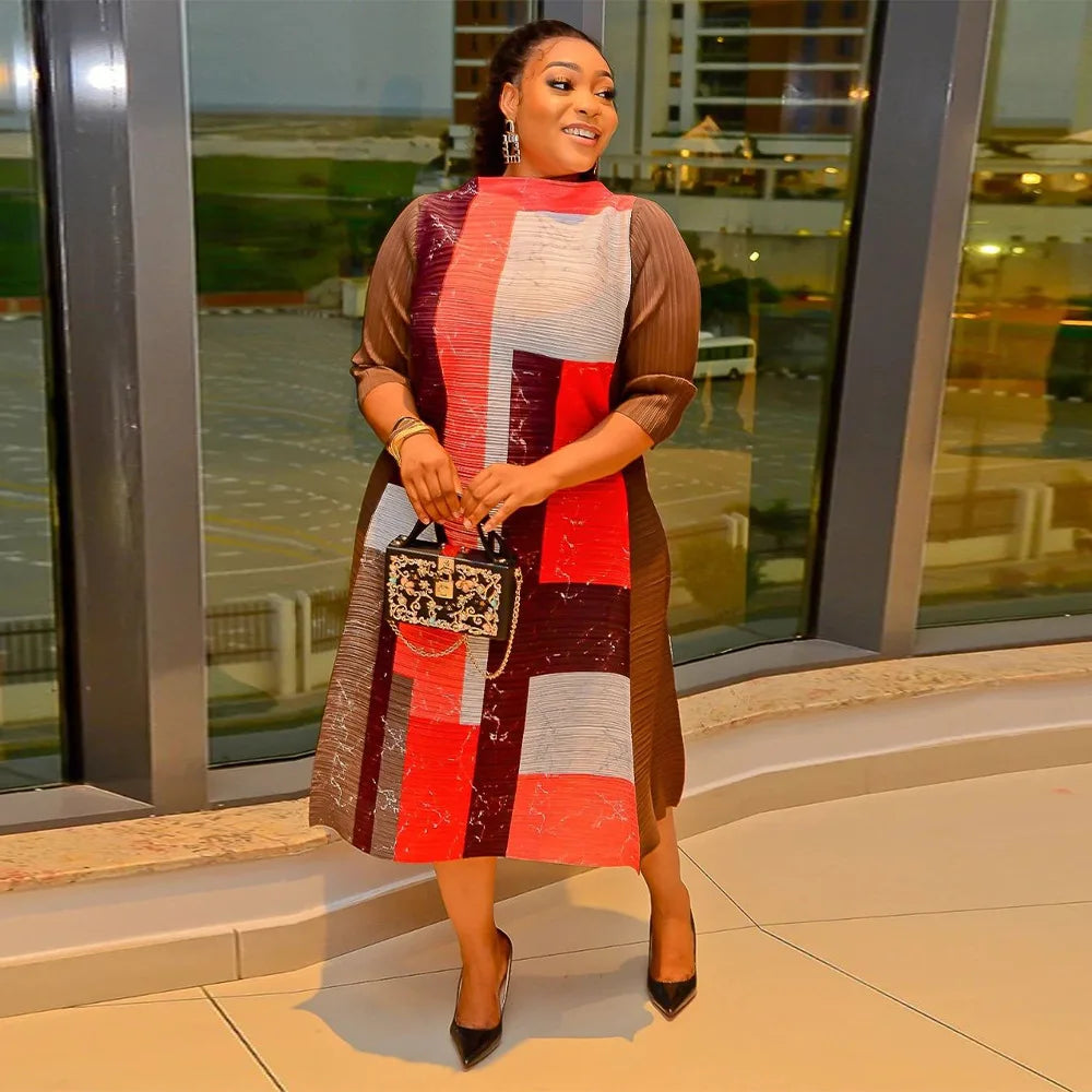 Vibrant purple plus size long dress emphasising an O-neckline and intricate pleats, perfect for sophisticated African-inspired fashion.