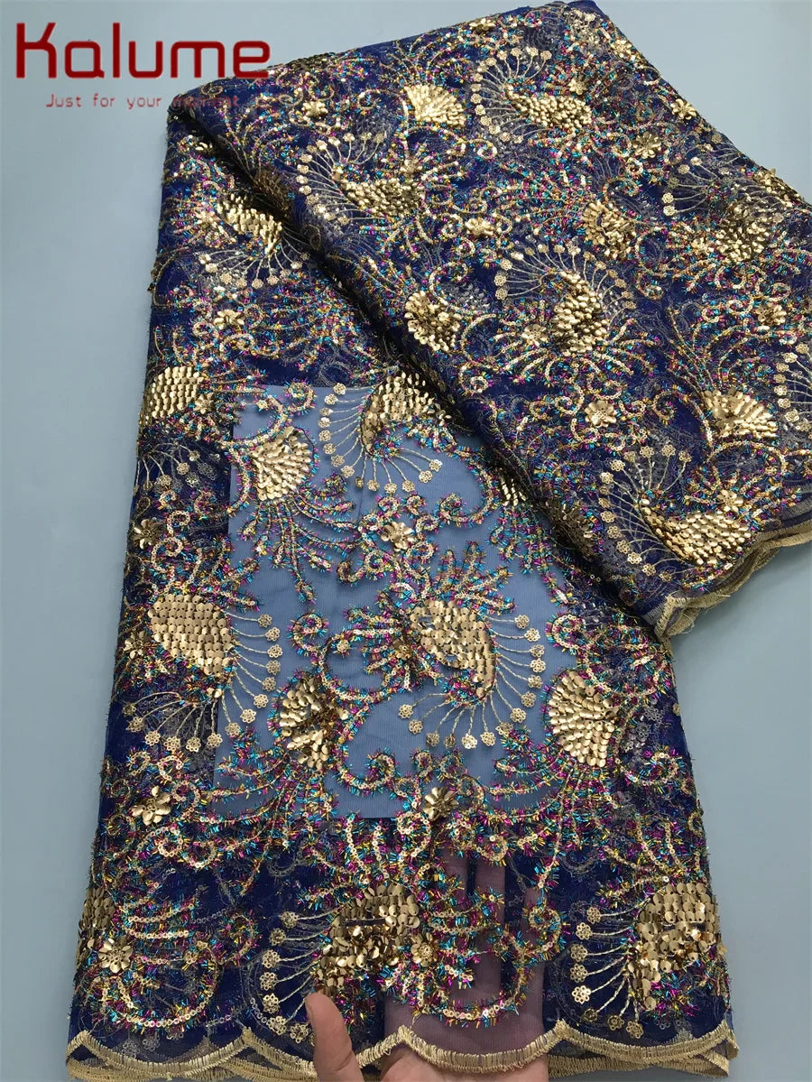 Luxurious 120cm wide mesh lace fabric by Kalume, embellished with sequins, perfect for bespoke gowns and glamorous event wear.