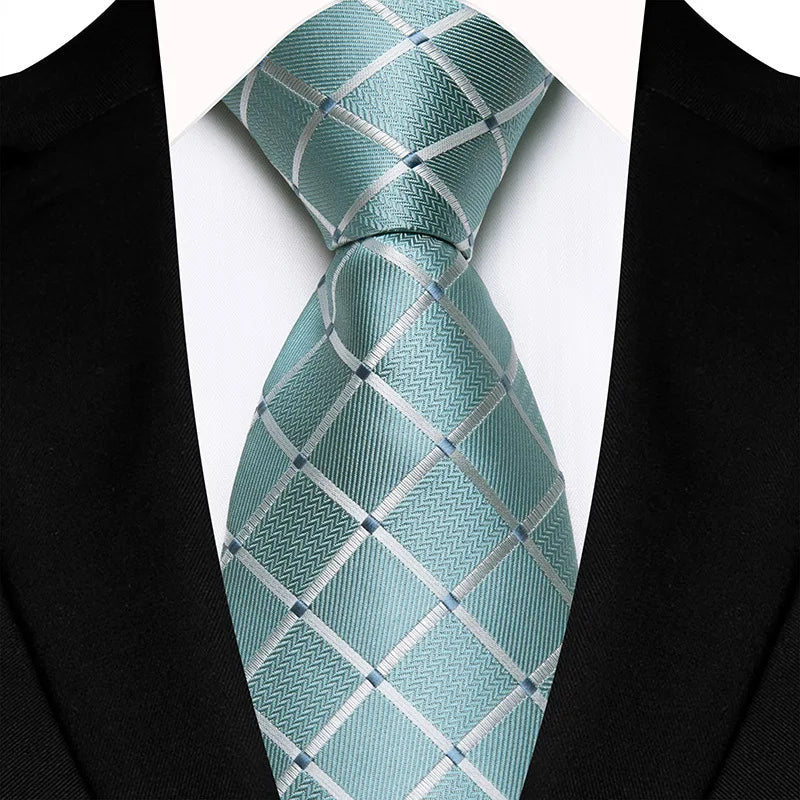 Close-up of a premium quality necktie featuring intricate floral jacquard woven patterns amidst green and blue stripes, ideal for formal occasions.