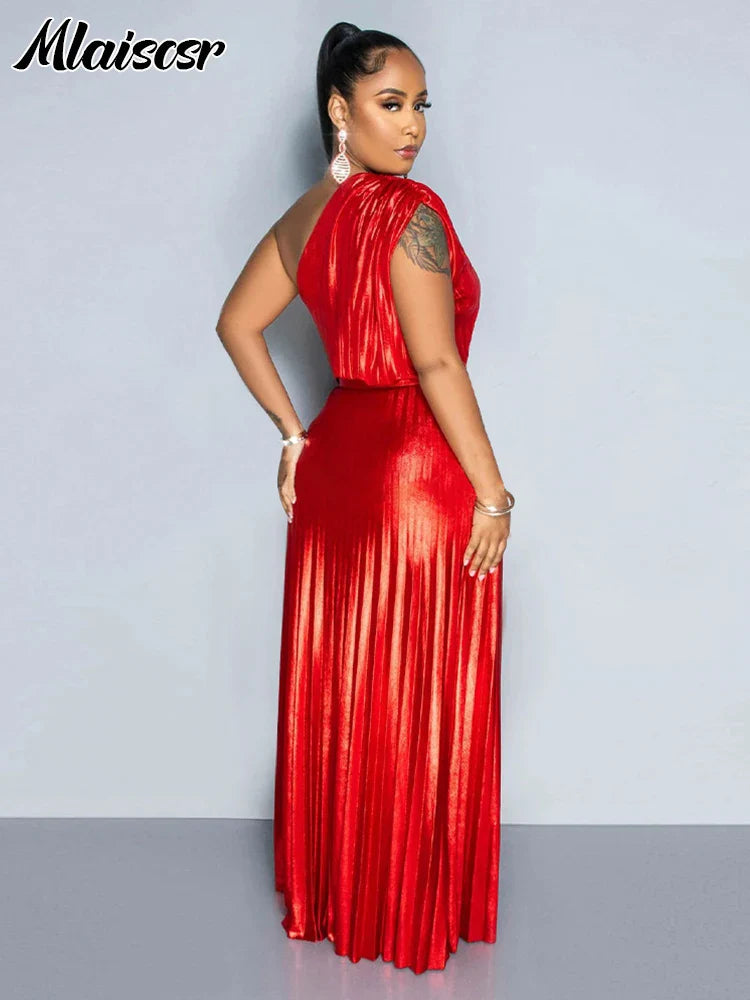 Side profile of a woman wearing a one-shoulder metallic gold evening dress, highlighting the elegant silhouette and stylish design.