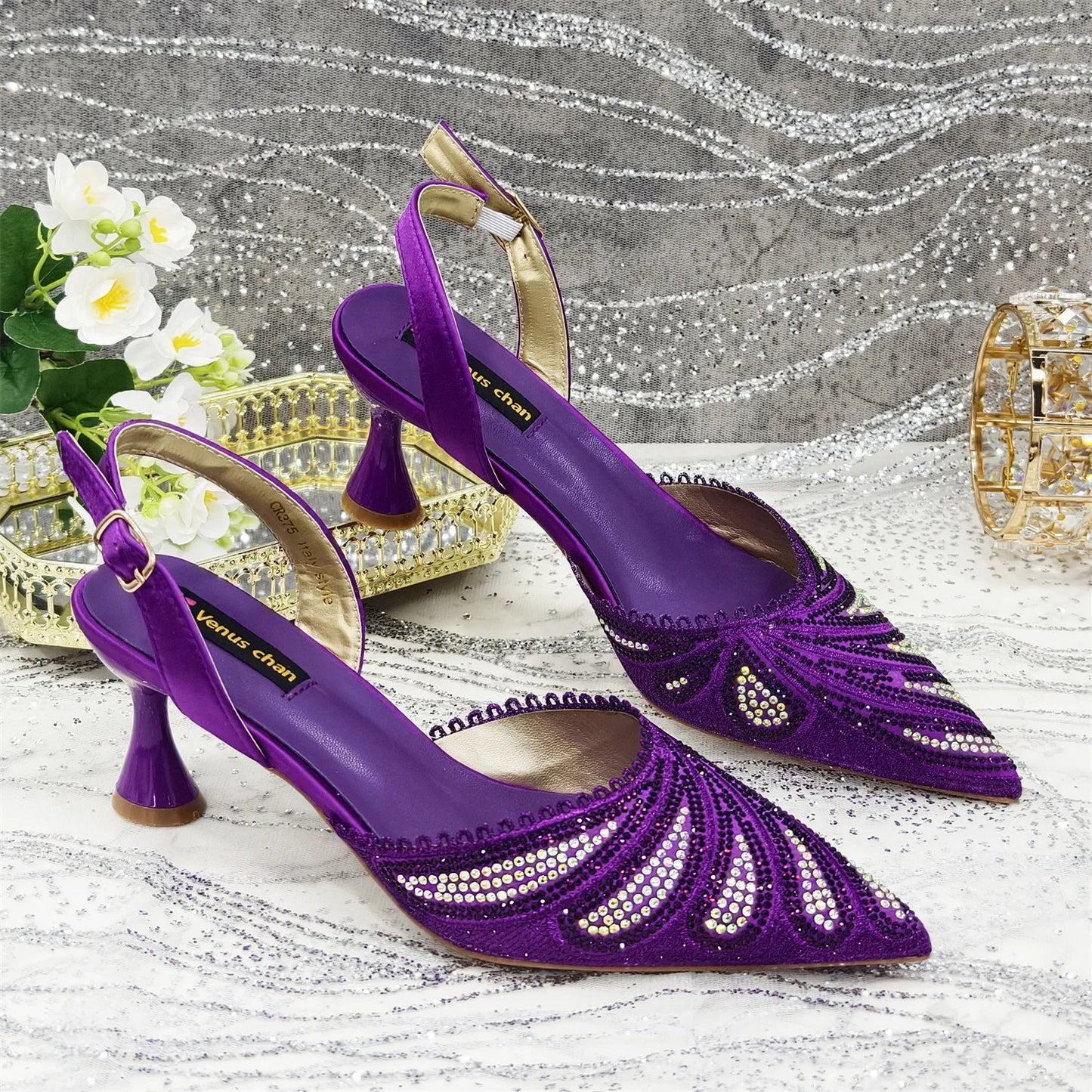 Close-up view of high-quality pointed toe pump shoes embellished with diamonds, perfect for special events.