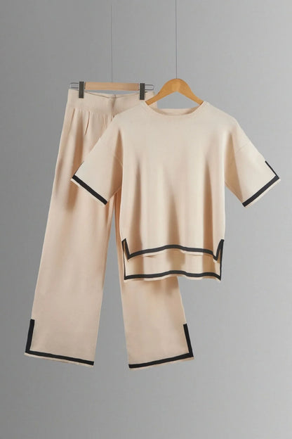 Ankle-length wide-leg trousers paired with a short-sleeved pullover in an elegant knitted suit, suitable for middle-aged women seeking timeless fashion.