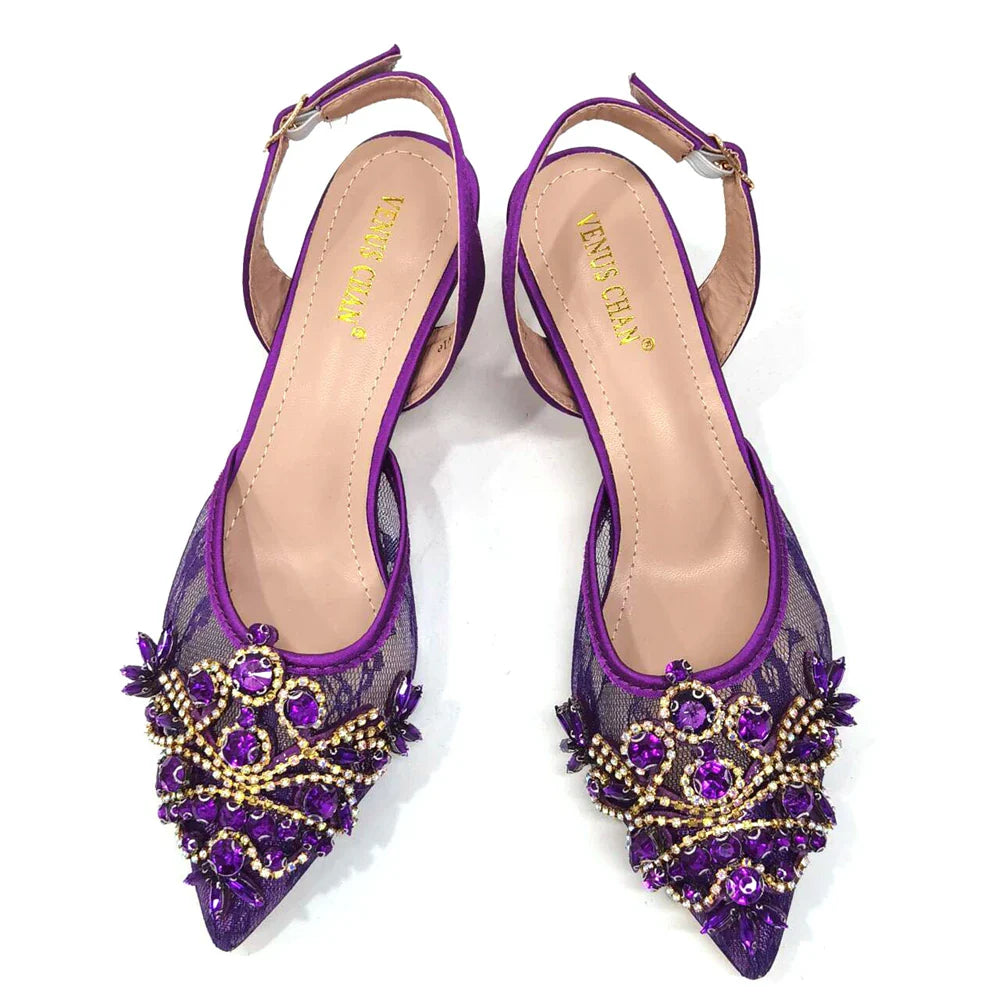 Luxurious green lace shoes featuring spike heels, complemented by a matching mini handbag.