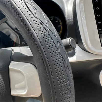 Elegant 15-inch Napa leather steering wheel cover showcasing a breathable perforated pattern, perfect for a premium car interior.