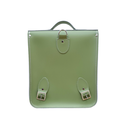 Stylish and compact handmade sage green leather city backpack displayed with adjustable straps, ideal for comfort and urban mobility.