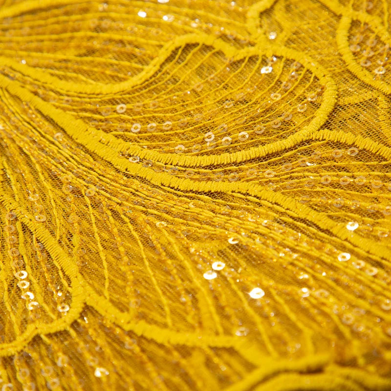 Stylish African lace fabric with sequins, beautifully crafted for wedding dresses, demonstrating a 51-52 inch width and eco-friendly materials, ideal for elegant bridal designs.