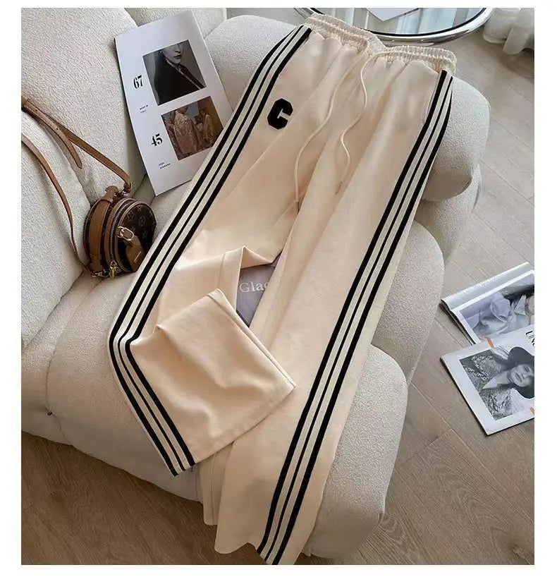 Luxurious women's autumn winter leisure two-piece sports set featuring wide leg pants and an intricately embroidered coat for an elegant high street look.